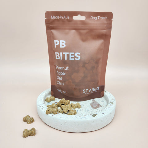 Close-up of premium dog gift box items including St Argo gourmet dog treats.